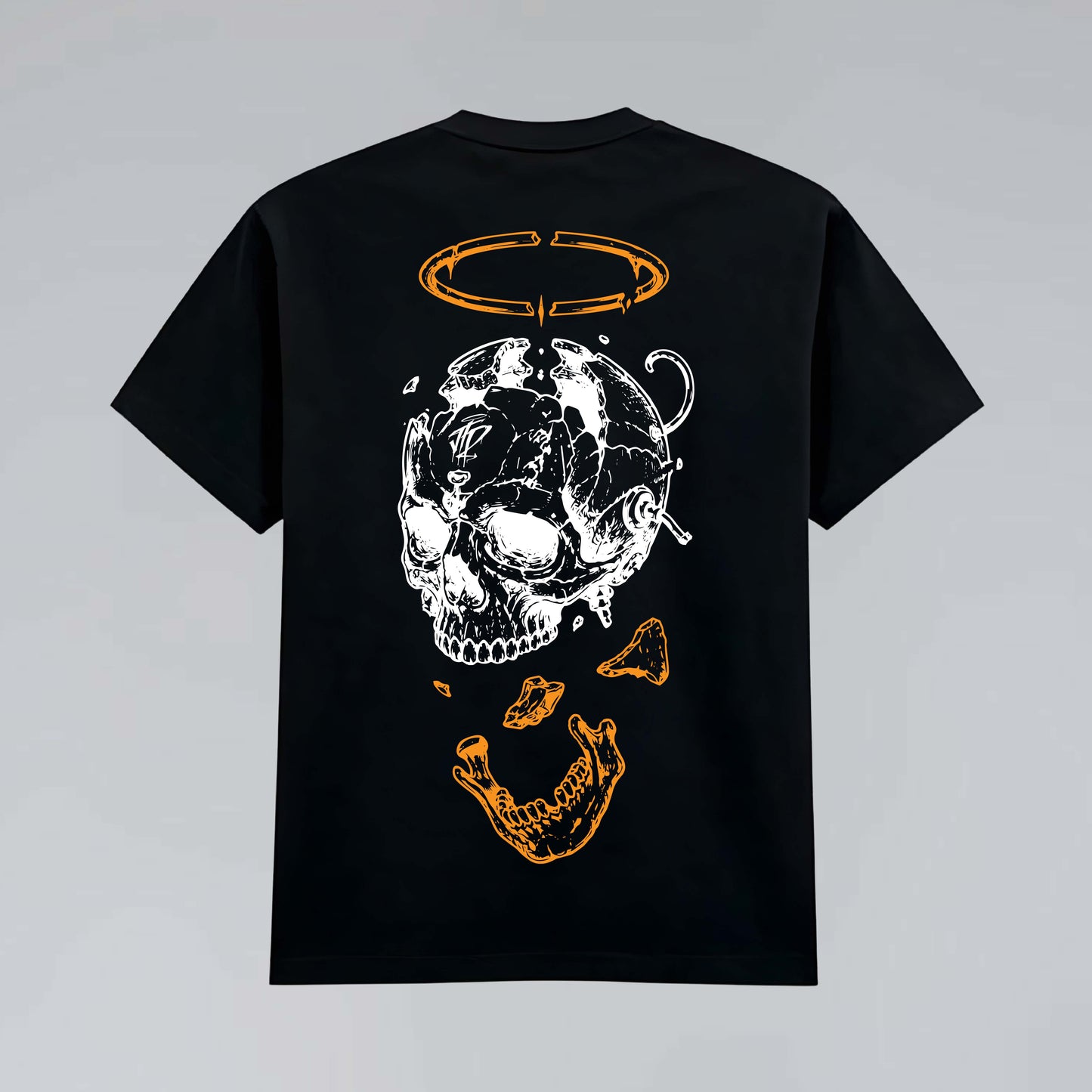 Black heavy graphic T-shirt flat lay featuring deconstructed skull illustration, bone fragments and broken orange halo