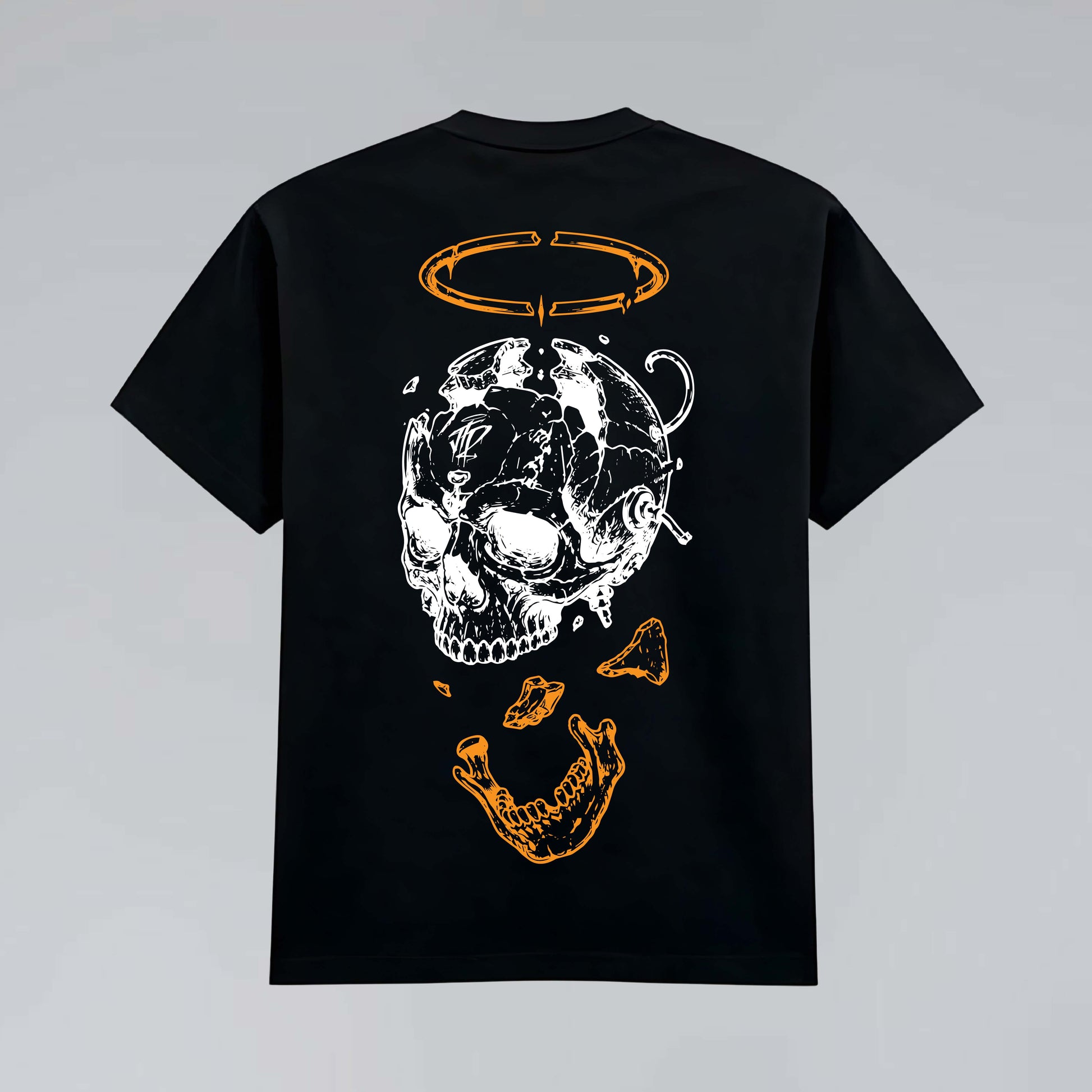 Black heavy graphic T-shirt flat lay featuring deconstructed skull illustration, bone fragments and broken orange halo