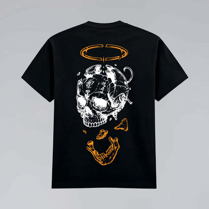Black heavy graphic T-shirt flat lay featuring deconstructed skull illustration, bone fragments and broken orange halo