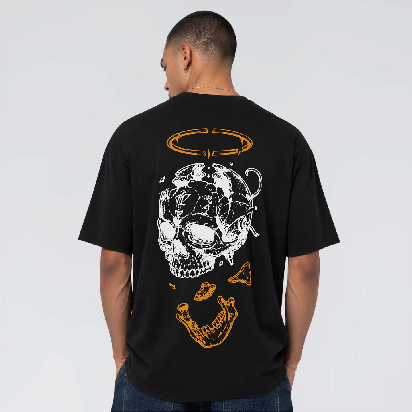 Black skull graphic tee displaying the Afterform fractured head artwork with suspended jaw and orange halo