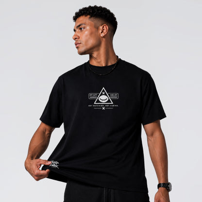 Male model wearing Blind Surveillance black cotton graphic tee by Jump the Dark.