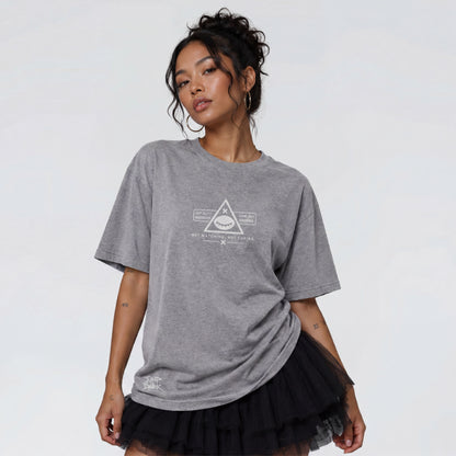 Female model wearing Blind Surveillance grey heavyweight graphic t-shirt by Jump the Dark.