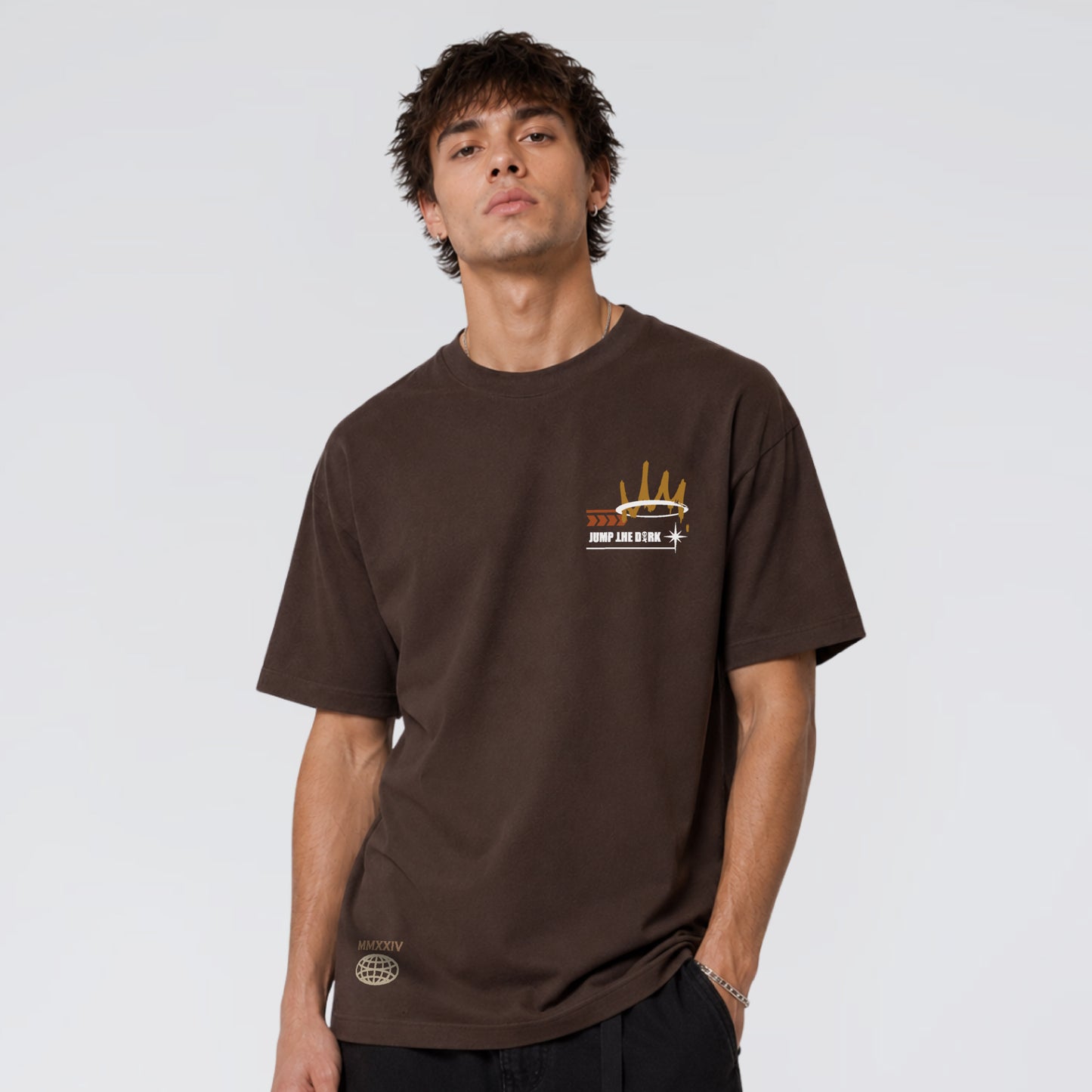 Male model wearing Broken Saint brown heavy graphic t-shirt by Jump The Dark 