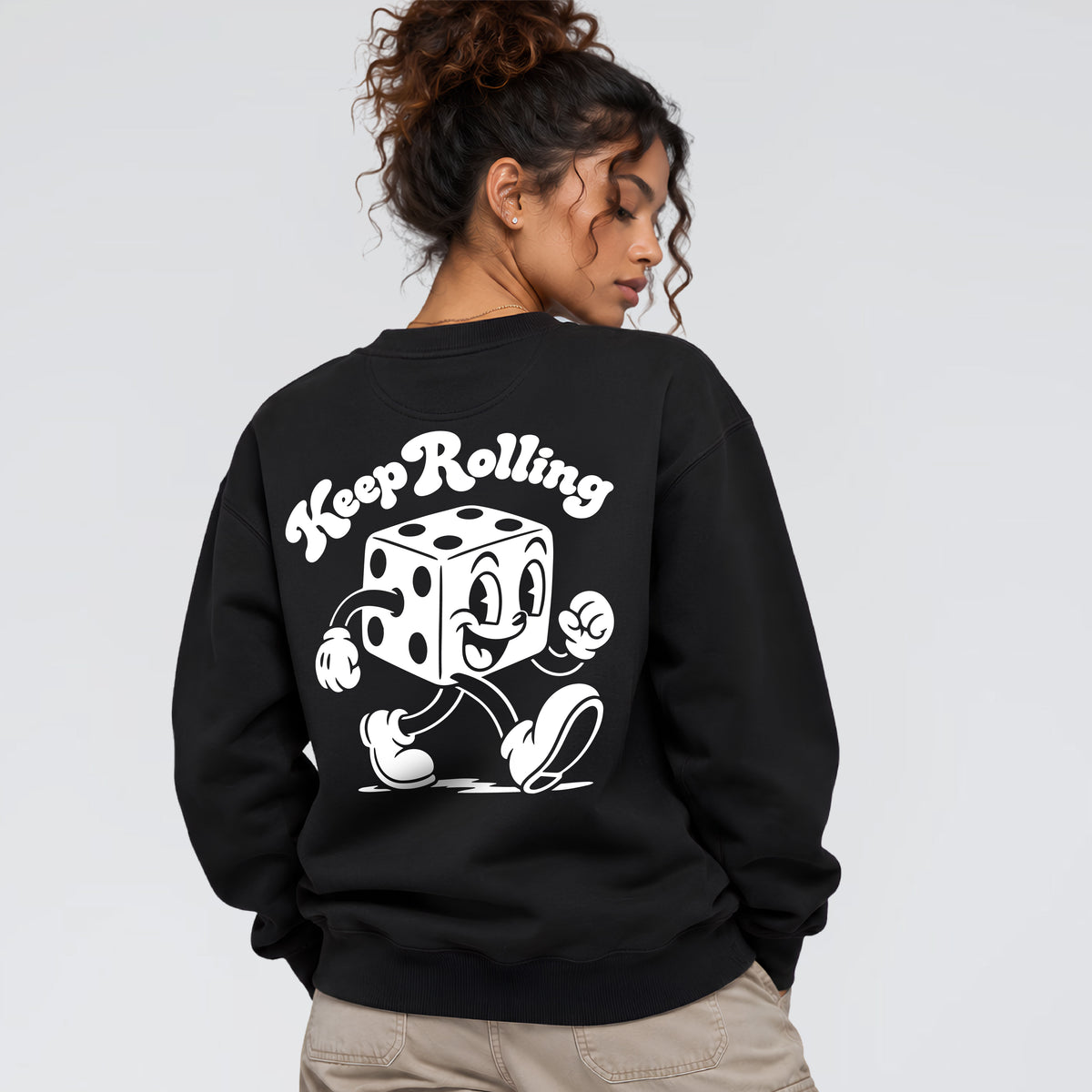 Keep Rolling sweatshirt worn from behind showing vintage walking dice character artwork