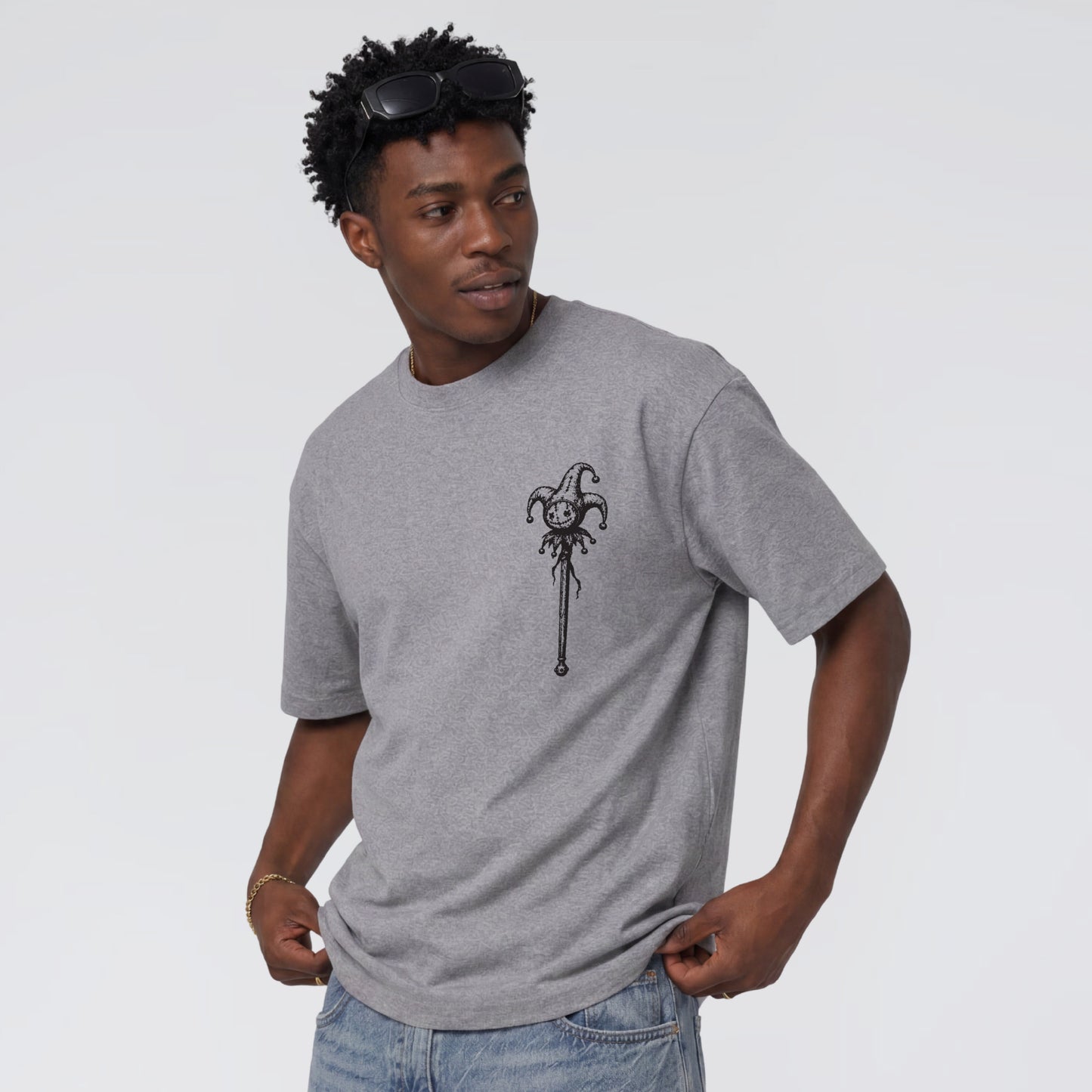 Male model wearing Midnight Jester unisex grey graphic tee.