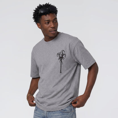 Male model wearing Midnight Jester unisex grey graphic tee.