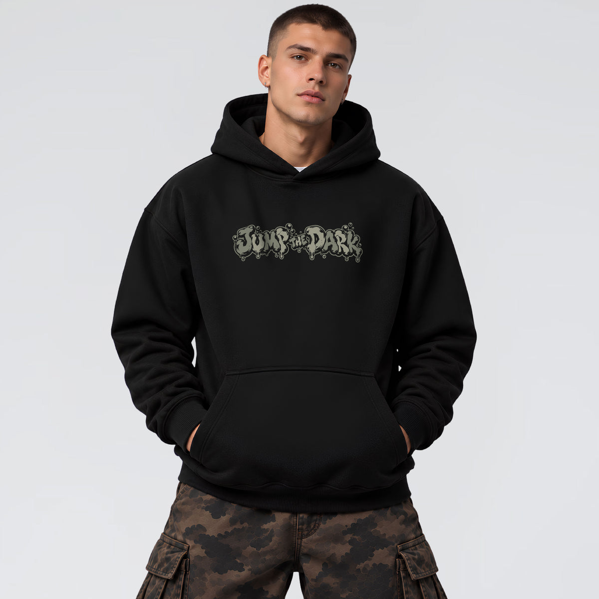 Male model wearing No Return black heavyweight hoodie with distressed Jump the Dark chest graphic