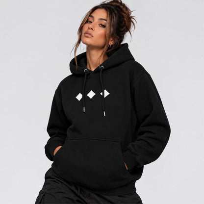 Female model wearing Raised Below black regular fit hoodie with minimal white diamond chest graphics