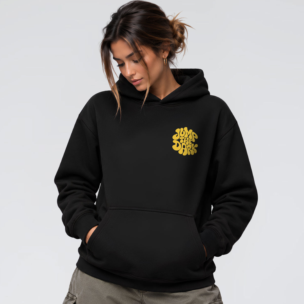 Female model wearing Retro Groove black heavyweight hoodie with yellow retro chest graphic