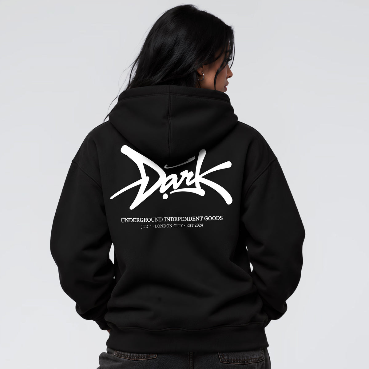 Signature black graphic hoodie on female model with oversized Jump the Dark back print