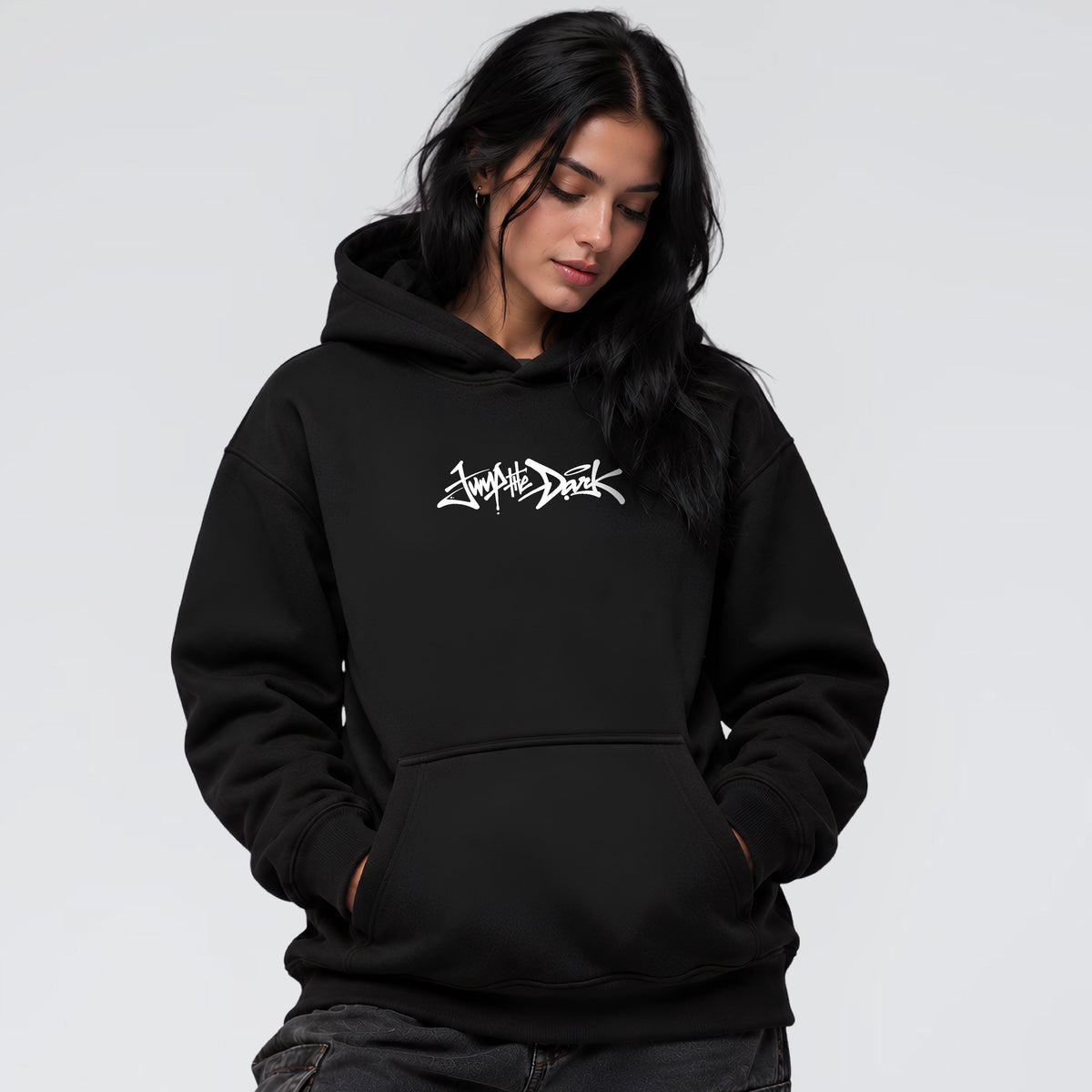 Female model wearing Signature black heavyweight streetwear hoodie with Jump the Dark chest logo
