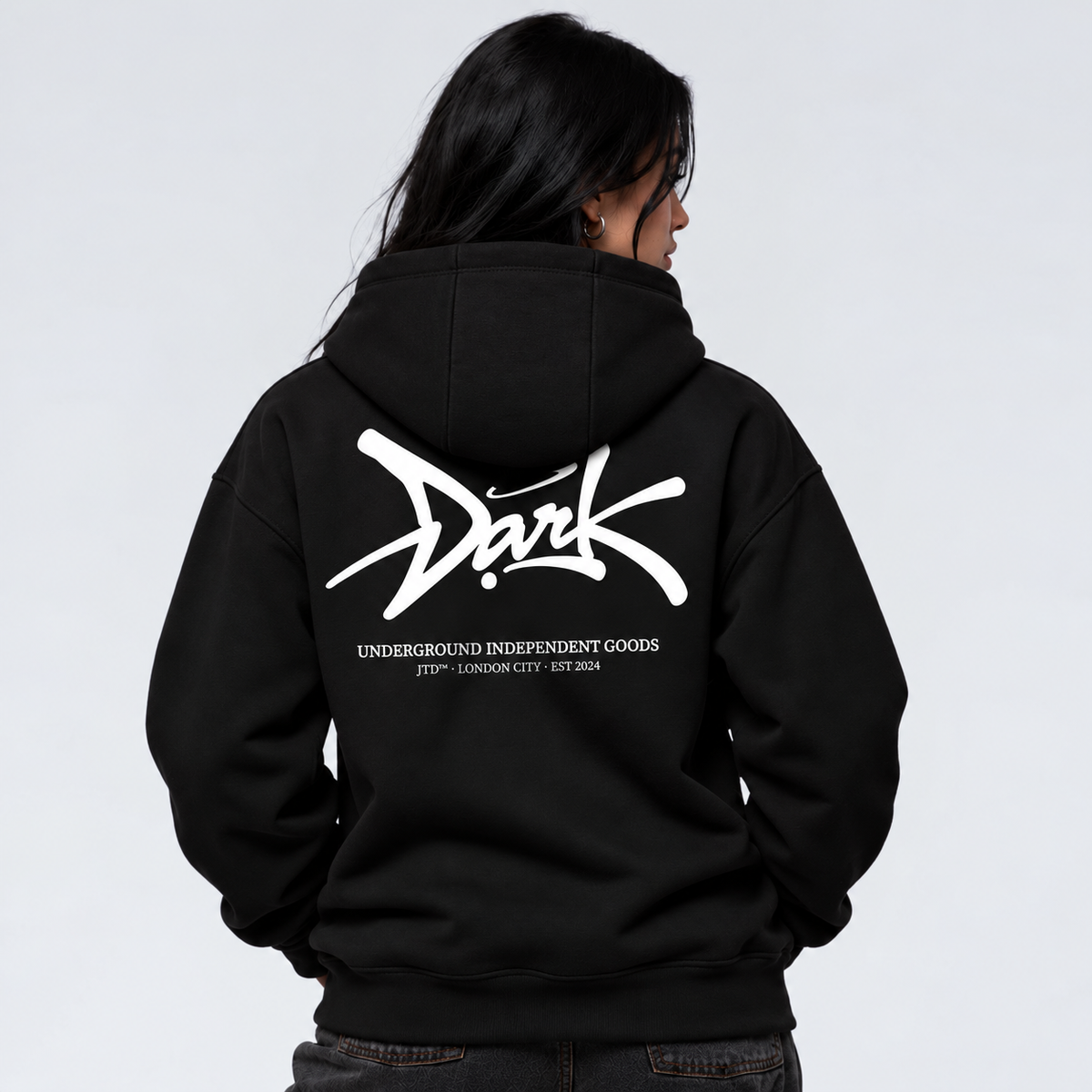 Signature black graphic hoodie on female model with oversized Jump the Dark back print