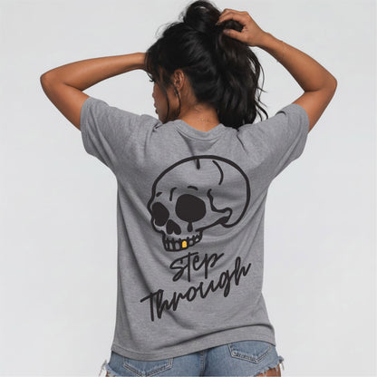 Female model wearing heather grey Jump the Dark Step Through t-shirt with large skull graphic 
