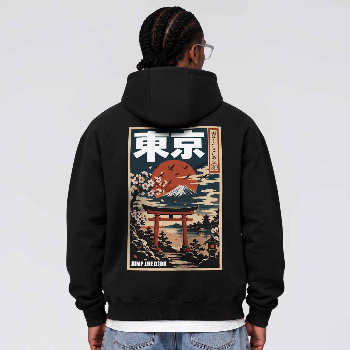 Male model wearing Tokyo After Dark Japanese graphic hoodie with Mount Fuji and torii gate back print