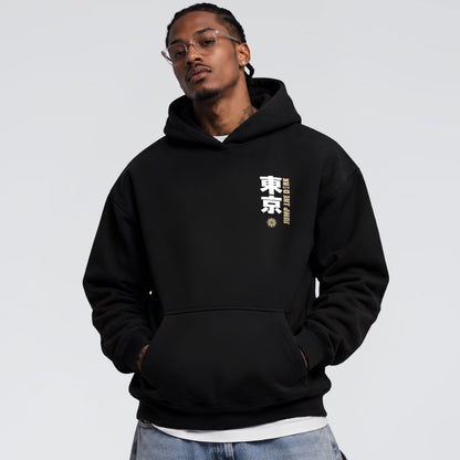 Male model wearing Tokyo After Dark black heavyweight hoodie with Japanese chest graphic