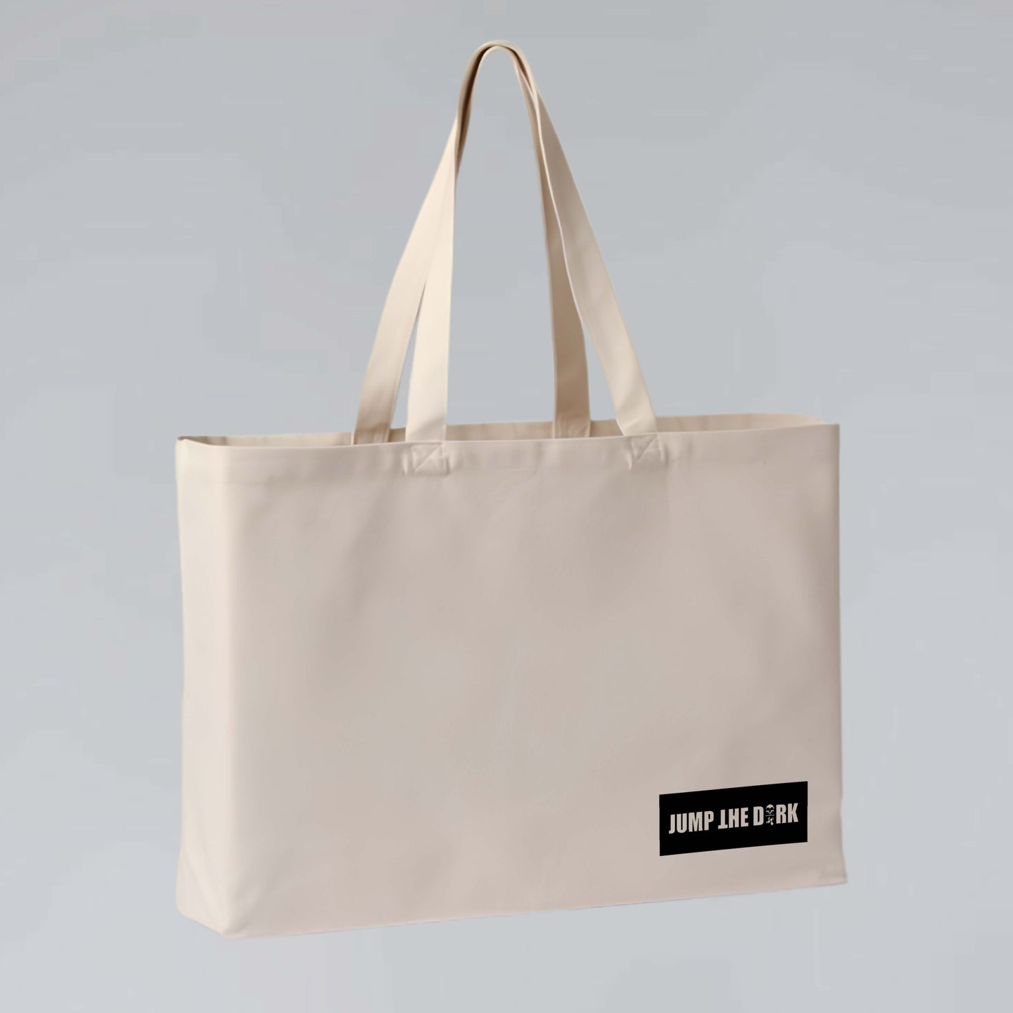 Heavyweight 38L tote showing minimal Jump the Dark logo on natural cotton canvas