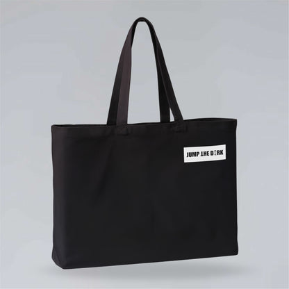 Heavyweight black canvas carryall with contrasting Jump the Dark logo